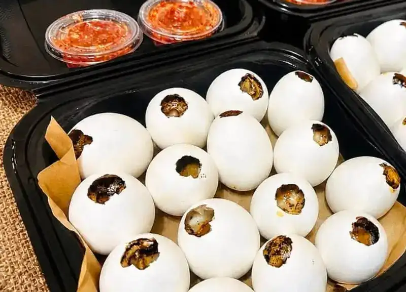 Trays of baked eggs with house chili sauce