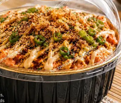 Sushi bake pie topped with spicy mayo, green onions and sesame